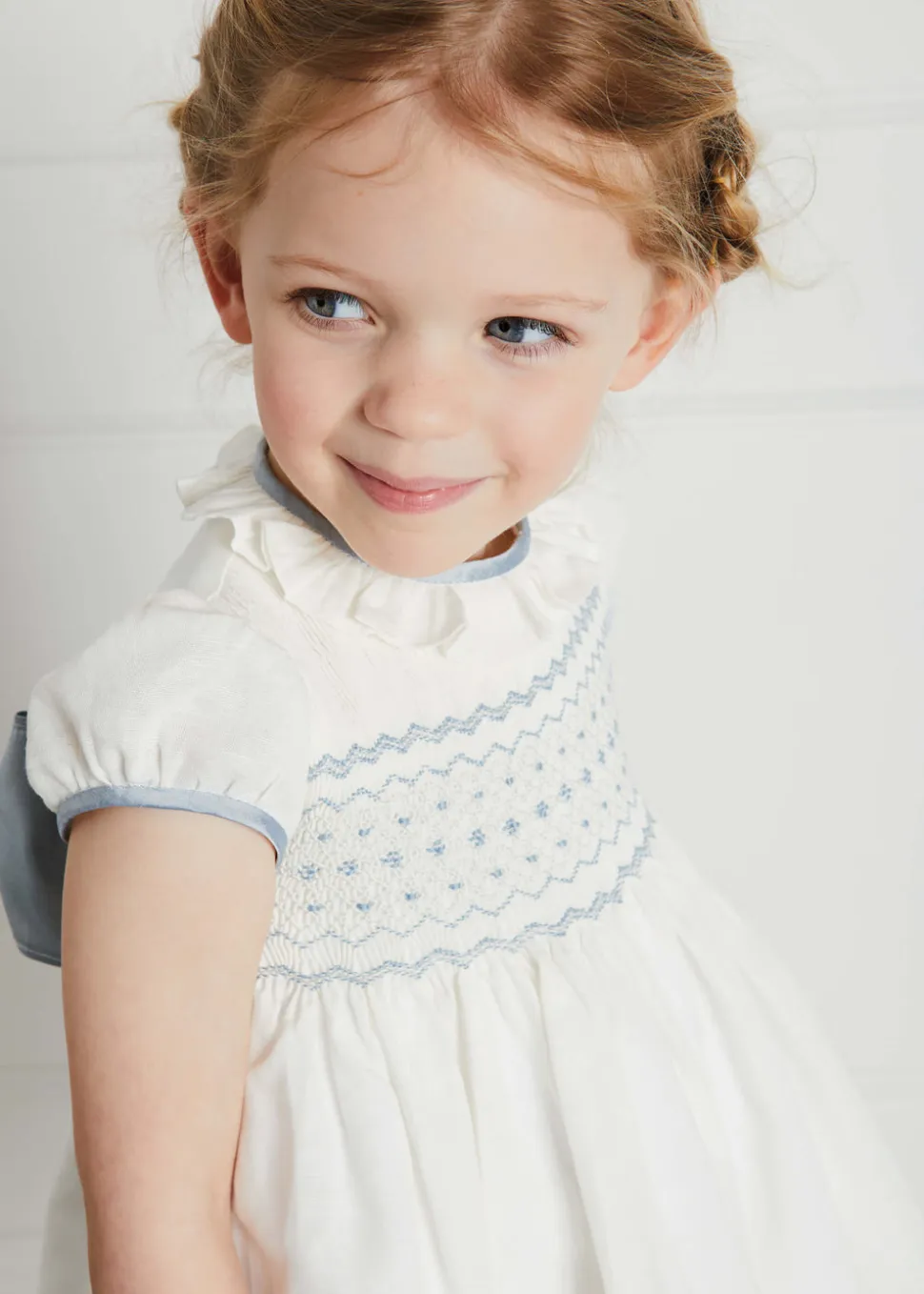 Hand Smocked Occasion Dress in Ivory with Blue Details